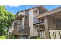 Beautiful exterior view of a condo featuring decks, neutral tones and lush green landscaping at 12804 Wedgewood Way # C, Hudson, FL 34667