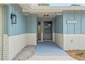 Inviting entryway showcasing stylish exterior lighting, clear address numbers, and modern design elements at 13211 111Th Ln, Largo, FL 33778