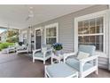 Inviting front porch with cozy seating, creating a relaxing outdoor space to enjoy the neighborhood views at 157 9Th N Ave, St Petersburg, FL 33701
