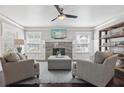 Inviting living room featuring a stone fireplace, large windows, and comfortable seating, perfect for relaxation at 157 9Th N Ave, St Petersburg, FL 33701