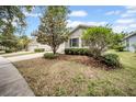 Attractive home featuring tidy landscaping, dark shutters, and a lovely front yard at 15810 Starling Water Dr, Lithia, FL 33547