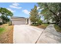 Well-maintained single Gathering home with a long driveway and manicured landscaping at 15810 Starling Water Dr, Lithia, FL 33547