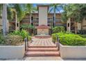 Beautiful building exterior with landscaping and a fountain in the center at 2400 Feather Sound Dr # 1136, Clearwater, FL 33762