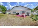 Spacious backyard featuring a cozy patio area, perfect for outdoor dining and entertaining at 24305 Denali Ct, Lutz, FL 33559