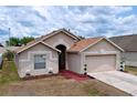 Charming single-Gathering home featuring a well-maintained lawn and a two-car garage at 24305 Denali Ct, Lutz, FL 33559