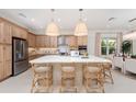 Bright kitchen boasts a large center island with seating, stainless steel appliances, and ample cabinet space at 32249 Tribeca Ave, Wesley Chapel, FL 33543