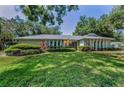 Well-maintained one-story home featuring a lush green lawn and lovely landscaping at 3416 W Morrison Ave, Tampa, FL 33629