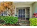 Close-up of a home's charming gated front entrance with a blue double door at 3416 W Morrison Ave, Tampa, FL 33629