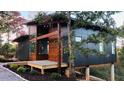 Contemporary home featuring wood and dark panel siding with an elevated deck at 344 Bay St, Palm Harbor, FL 34683