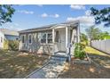 Quaint one-story home boasts fresh exterior paint, a covered porch, and tidy front yard at 3535 16Th N St, St Petersburg, FL 33704