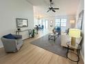 Inviting living room featuring light wood floors, neutral furniture, and an open layout at 3621 102Nd N Pl, Clearwater, FL 33762