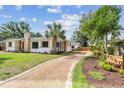 Exterior shot featuring a gravel driveway and verdant landscaping at 4560 7Th N Ave, St Petersburg, FL 33713