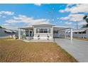 Well-kept home with covered carport and tidy landscaping, creating a welcoming curb appeal in a serene setting at 5251 Flint St, Zephyrhills, FL 33542