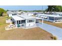 Inviting home showcases a covered carport and charming outdoor seating, perfect for relaxation and entertaining guests at 5251 Flint St, Zephyrhills, FL 33542