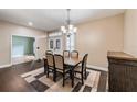 Formal dining room featuring a decorative rug, chandelier, and views into entry at 6038 Palomaglade Dr, Lithia, FL 33547