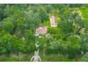 Expansive lot with mature trees, residence, and outbuilding with a red roof at 6234 Neff Lake Rd, Brooksville, FL 34601