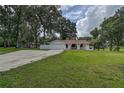 Well-maintained home with a two-car garage, large front yard and mature trees at 6234 Neff Lake Rd, Brooksville, FL 34601