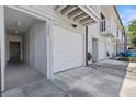 Exterior view of a townhome featuring an attached garage and a welcoming entryway at 6420 92Nd N Pl # 1205, Pinellas Park, FL 33782