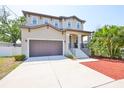 Well-maintained two-story home with a two-car garage and inviting front yard at 7307 S Morton St, Tampa, FL 33616