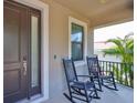 Cozy front porch with rocking chairs, perfect for relaxing and enjoying the neighborhood views at 7307 S Morton St, Tampa, FL 33616