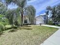 Charming single-Gathering home with a two-car garage and mature trees on a lush, green lawn at 7504 Turtle View Dr, Ruskin, FL 33573
