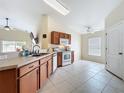 Kitchen with white tile floors, ceiling fan, and white appliances with lots of natural light at 7504 Turtle View Dr, Ruskin, FL 33573