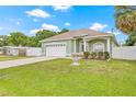 A well kept single-story house featuring a two car garage, and lovely landscaping at 7612 S 36Th Ave, Tampa, FL 33619