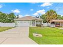 Inviting single-story home with beautiful landscaping, and a two car garage with long driveway at 7612 S 36Th Ave, Tampa, FL 33619