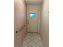Entryway featuring a tiled floor, grab bar and a front door with a small window at 7951 58Th N Ave # 106, St Petersburg, FL 33709