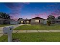 Lovely single-Gathering home at twilight with a well-maintained lawn and classic mailbox at 811 Pebblewood Dr, Brandon, FL 33511
