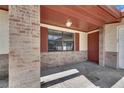Covered front porch with brick columns, painted ceiling, and a traditional exterior door at 811 Pebblewood Dr, Brandon, FL 33511