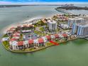 Waterfront condominiums with red tile roofs are nestled along the tranquil bay, offering scenic views and convenient parking at 868 Bayway Blvd # 206, Clearwater Beach, FL 33767