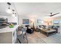 Open floor plan with modern furniture, bar seating, and soothing decor providing a comfortable and stylish living space at 868 Bayway Blvd # 206, Clearwater Beach, FL 33767