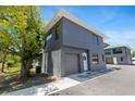Contemporary two-story townhouse featuring a gray exterior, garage, and minimalist design at 8723 Palm Ranches Pl, Tampa, FL 33614