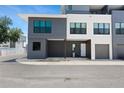 Contemporary townhouse with a gray and white facade, featuring a covered parking area at 8723 Palm Ranches Pl, Tampa, FL 33614