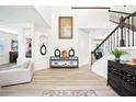 Grand foyer with high ceilings, modern decor, a staircase with an iron railing, and luxury vinyl flooring at 9203 Meadow Lane Ct, Tampa, FL 33647