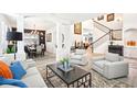 Spacious living room showcasing open layout, modern decor, and seamless flow to the dining area at 9203 Meadow Lane Ct, Tampa, FL 33647