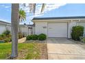 Charming home featuring a well-maintained front yard, decorative privacy wall and a one car garage at 93 Boca Ciega Point N Blvd # 93, St Petersburg, FL 33708