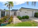 Charming home featuring a well-maintained front yard and decorative privacy wall under a clear blue sky at 93 Boca Ciega Point N Blvd # 93, St Petersburg, FL 33708