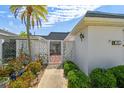 Charming home featuring a well-maintained front yard and decorative privacy wall under a clear blue sky at 93 Boca Ciega Point N Blvd # 93, St Petersburg, FL 33708