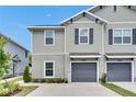 Attractive two-story townhome with a single-car garage and manicured landscaping at 9665 Sweetwell Pl, Riverview, FL 33569