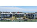 Multi-story condominiums overlooking boat docks, the inter coastal, and a community pool at 9815 Harrell Ave # 503, Treasure Island, FL 33706