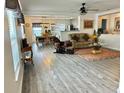 Bright living room with an open floor plan, featuring laminate floors and a comfortable seating area at 10607 Boyette Creek Blvd, Riverview, FL 33569
