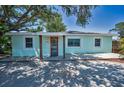 Charming single-story home featuring a welcoming front porch, complemented by fresh paint and a well-kept yard at 1101 Essex N Dr, St Petersburg, FL 33710