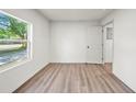 Minimalist bedroom with wood flooring and abundant natural light at 1108 E Annie St, Tampa, FL 33612