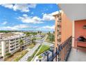 Balcony view of the waterfront with palm trees and a view of the ocean from a high-rise building on a sunny day at 1120 North Shore Ne Dr # 804, St Petersburg, FL 33701