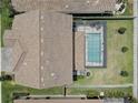 Aerial view of a fenced backyard featuring a screened-in pool and patio area at 11222 Hawks Fern Dr, Riverview, FL 33569