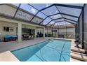 Backyard pool with screened enclosure and covered patio, perfect for outdoor entertaining at 11222 Hawks Fern Dr, Riverview, FL 33569
