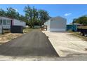 Wide shot showing the single story home, driveway, and landscaping at 11351 Edison Ave, New Port Richey, FL 34654