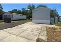 Back of single-story home with driveway at 11351 Edison Ave, New Port Richey, FL 34654